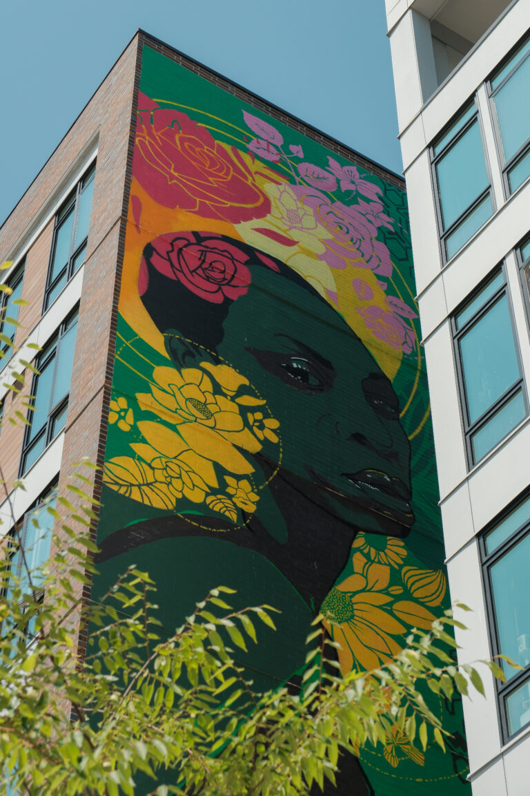 View of mural by artist Jite Agbro featuring the likeness of Ade Connere at Tapestry Apartments in Seattle, WA